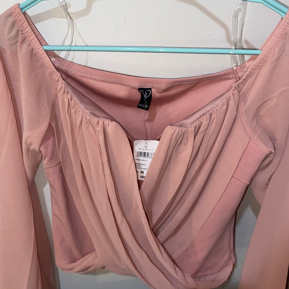 Pink cute shirt, new with tag on, off shoulders and size M